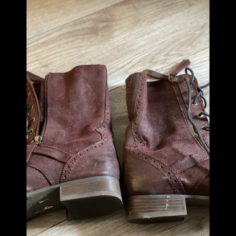 Burgundy lace up booths with zippers and buckle details